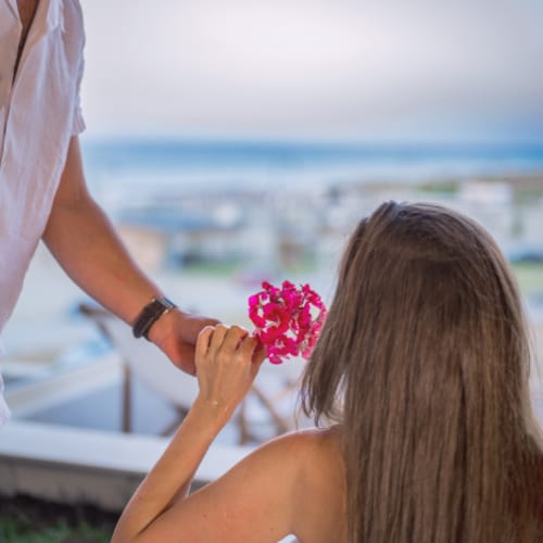 a woman holding a flower