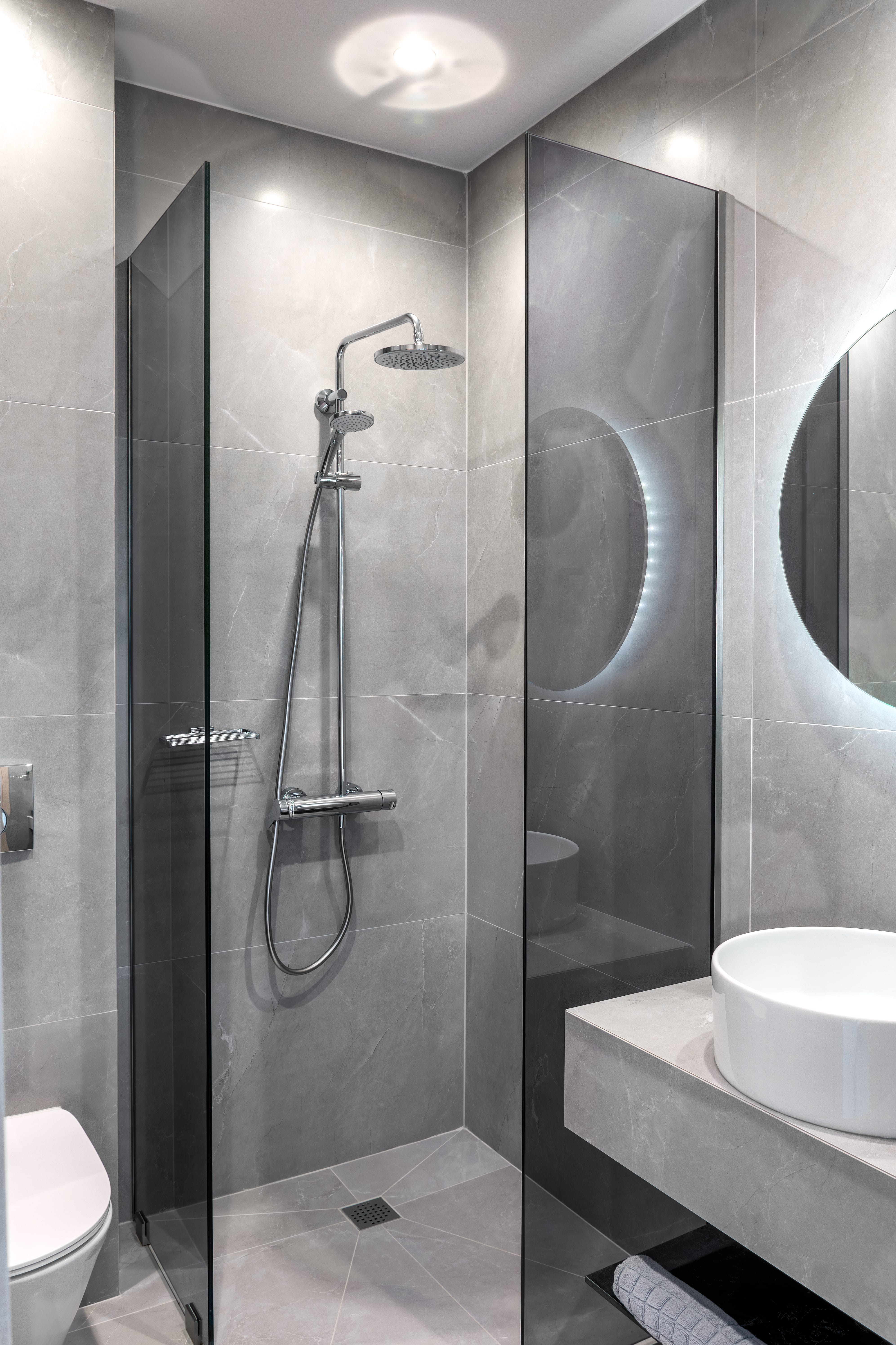 a bathroom with a shower unit and sink