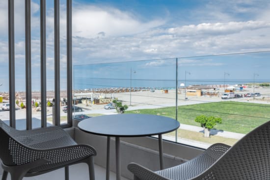a table and chairs on a balcony