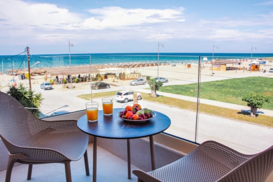 a table with food and drinks on it by a beach