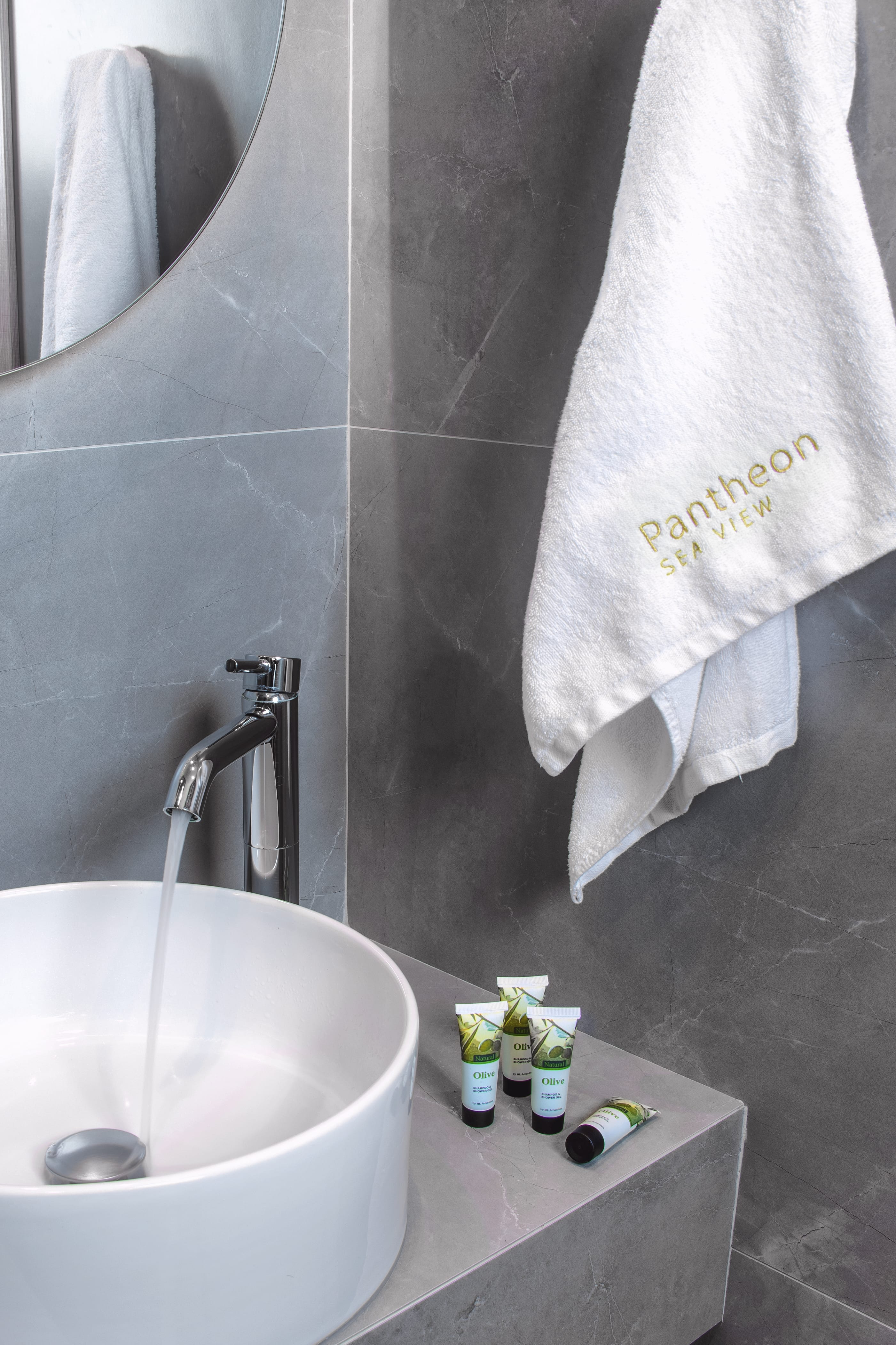 a bathroom with a sink and a towel on the wall