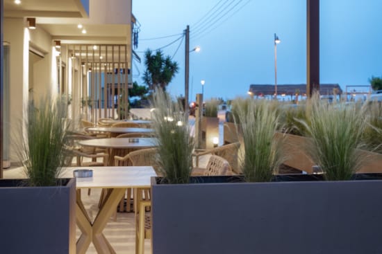 a patio with tables and chairs