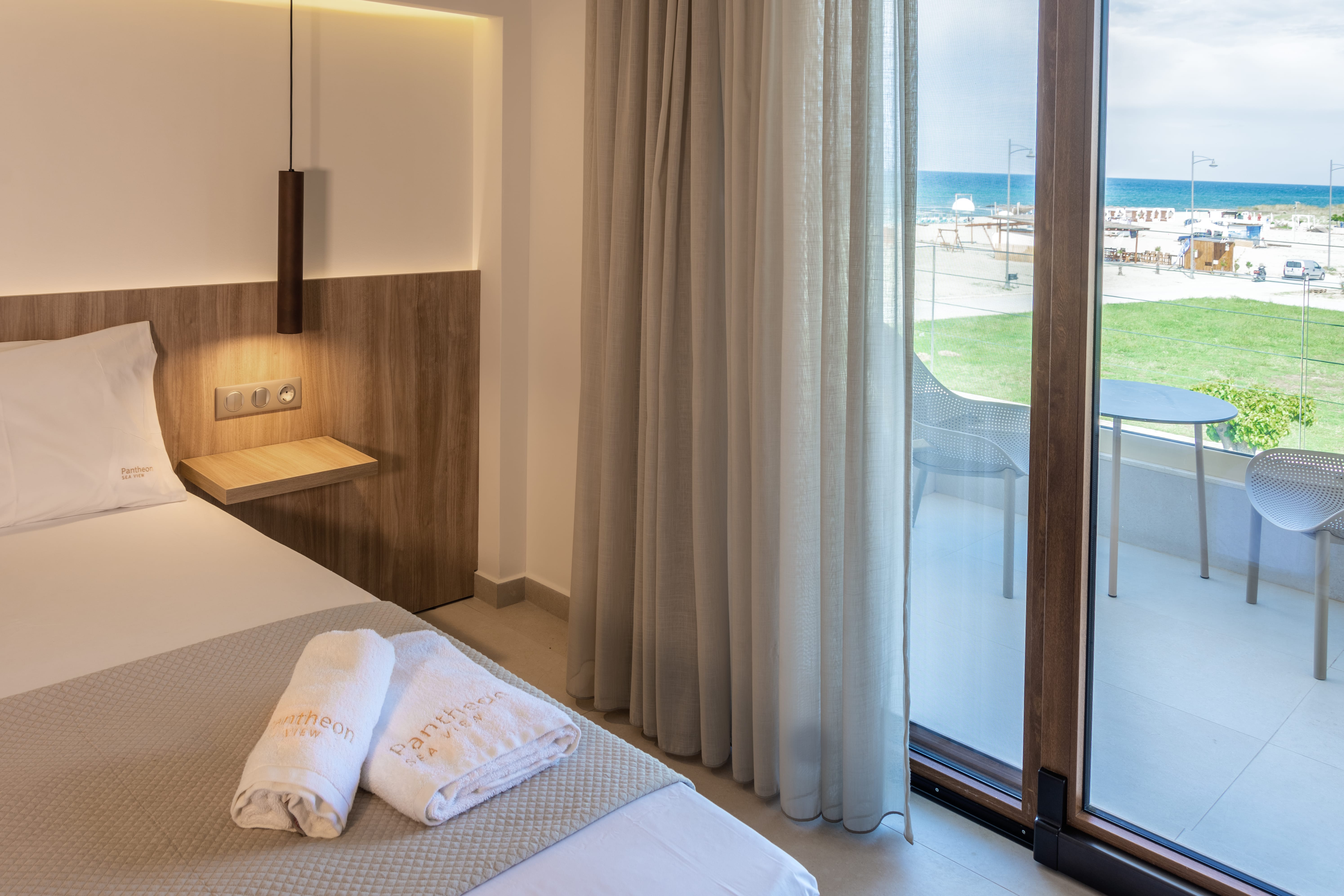 a room with a bed and a window with a view of a city