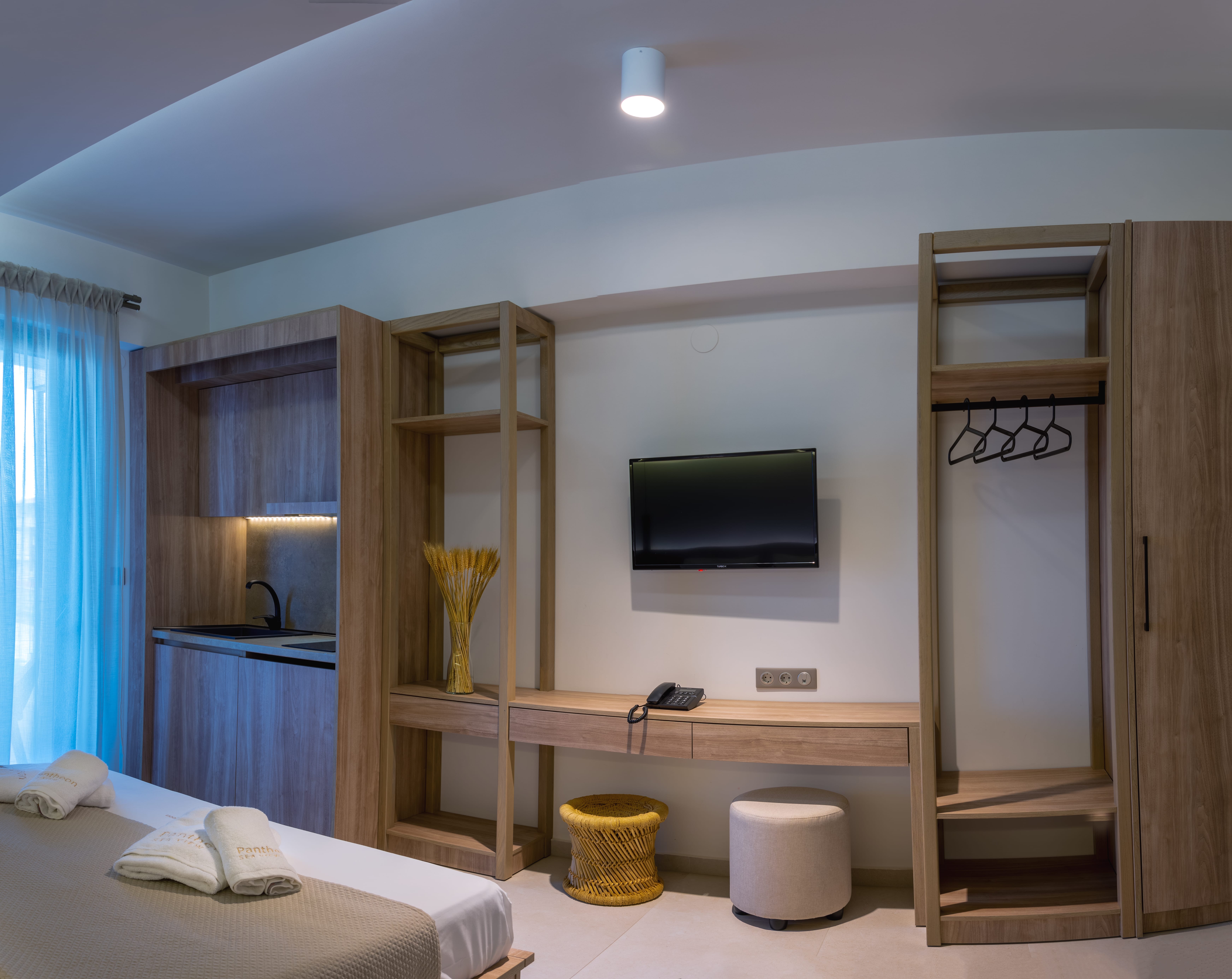 a bedroom with a tv and a bed