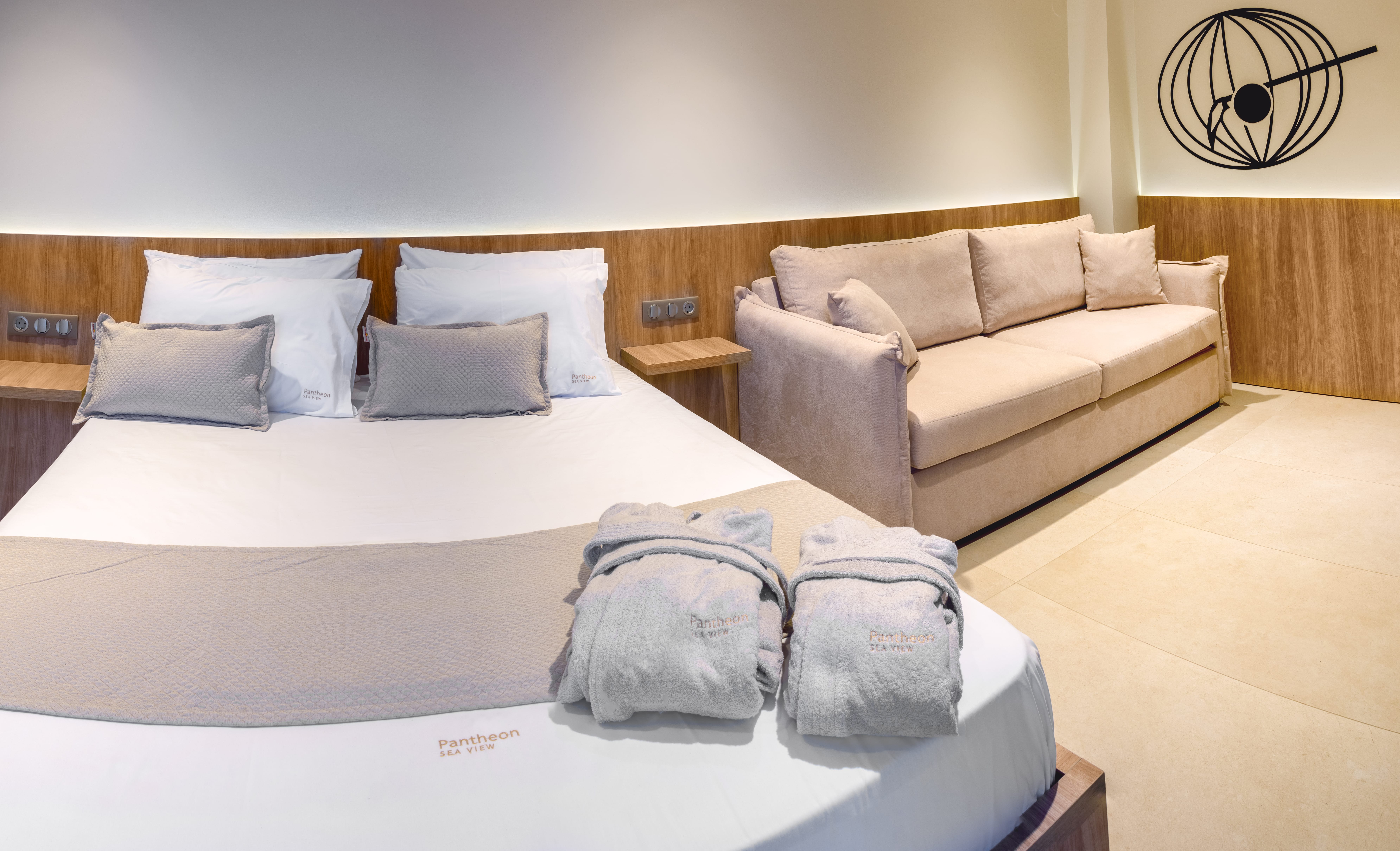 a bed with pillows and a couch