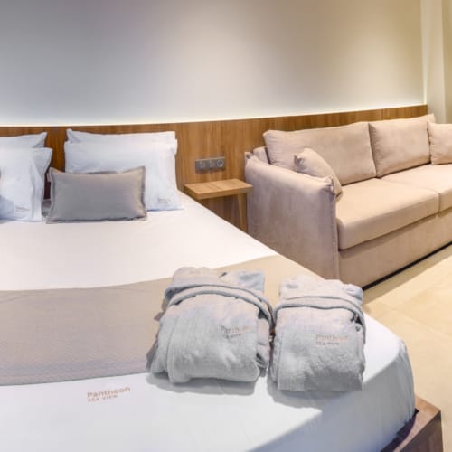 a bed with pillows and a couch