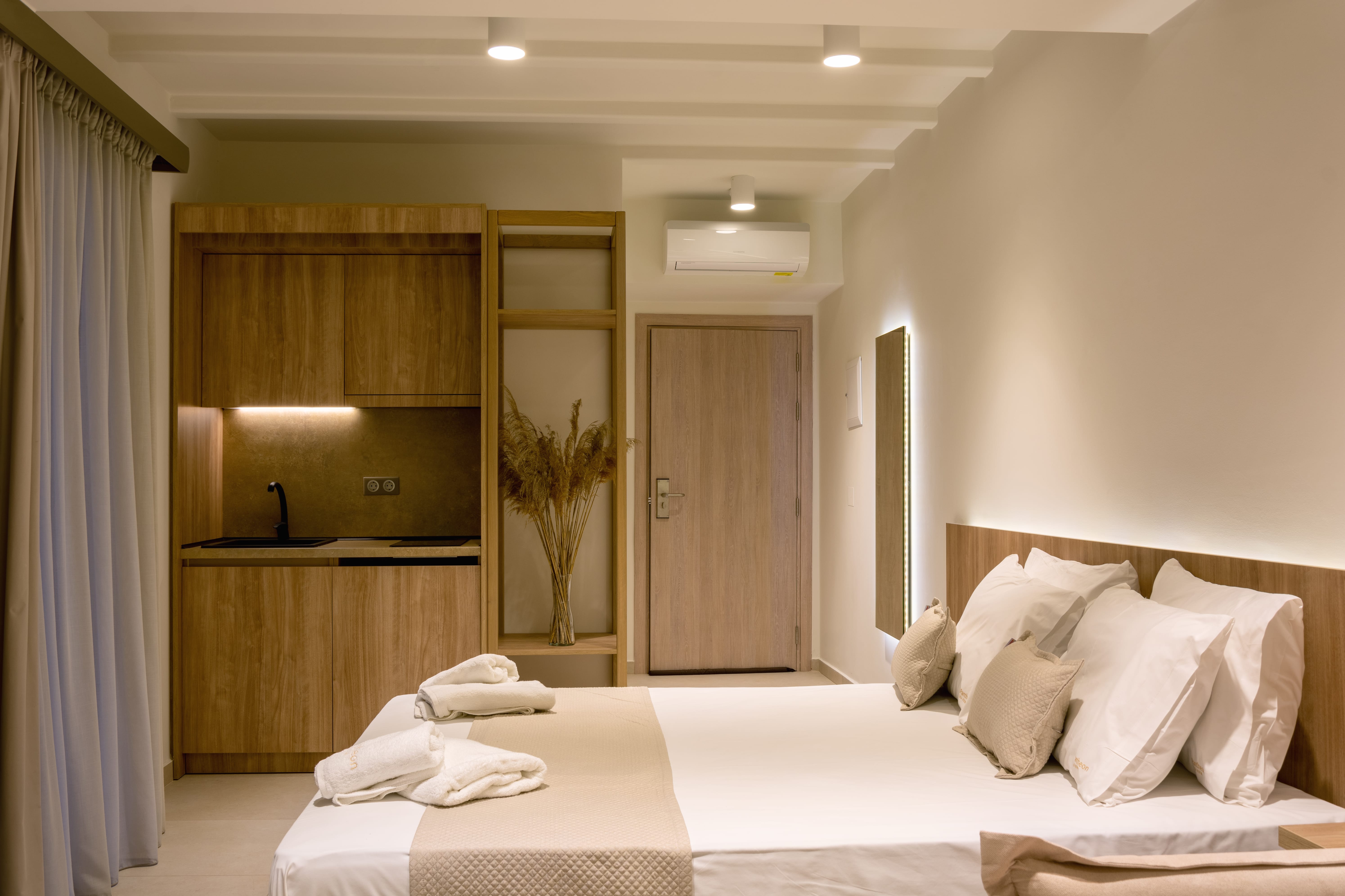 a hotel room with a bed and a plant