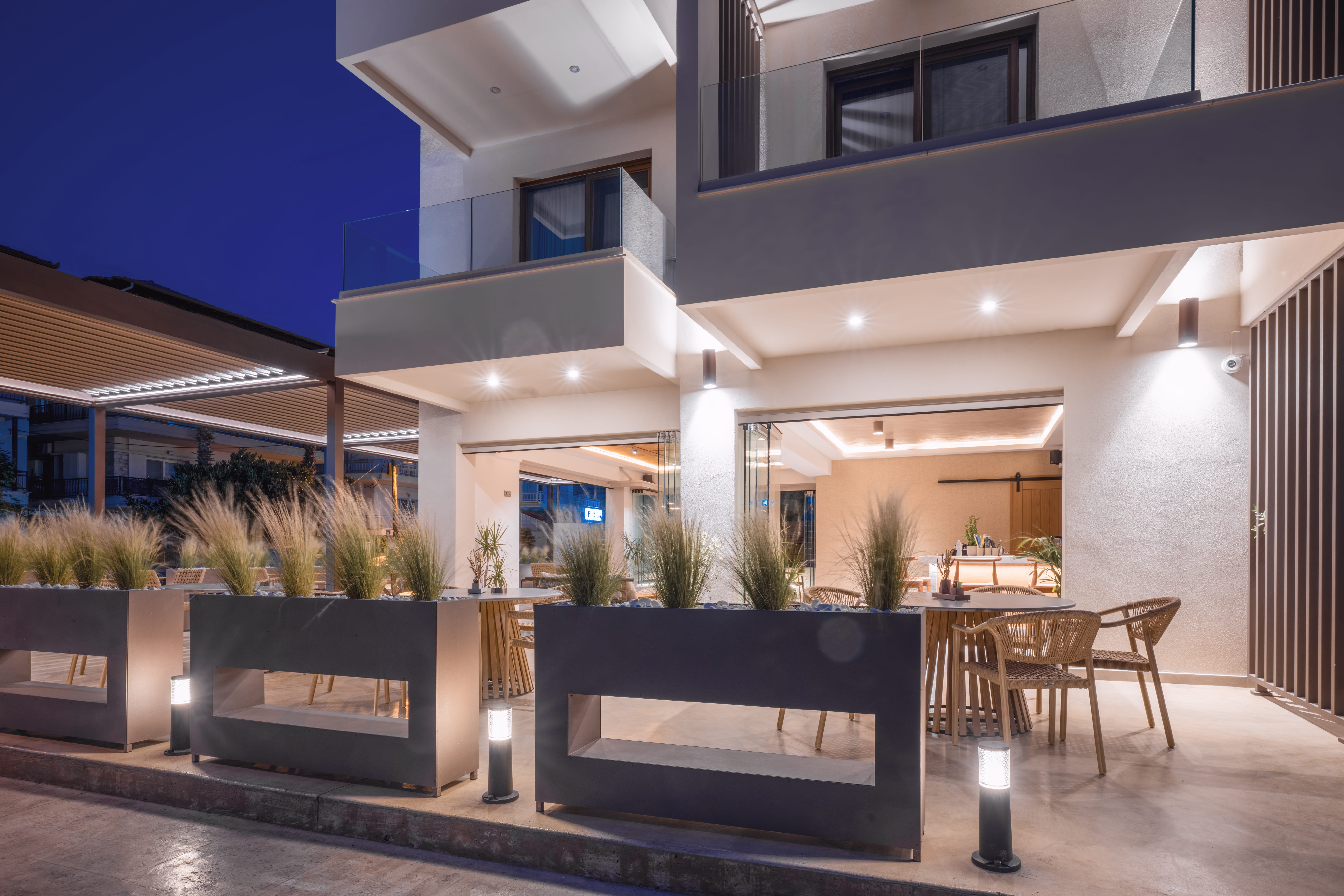 a building with a pool and chairs