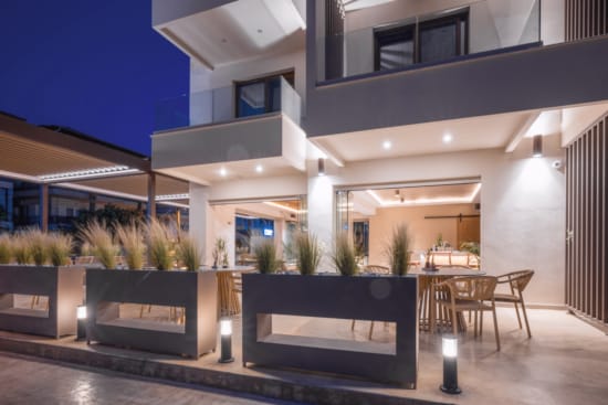 a building with a pool and chairs