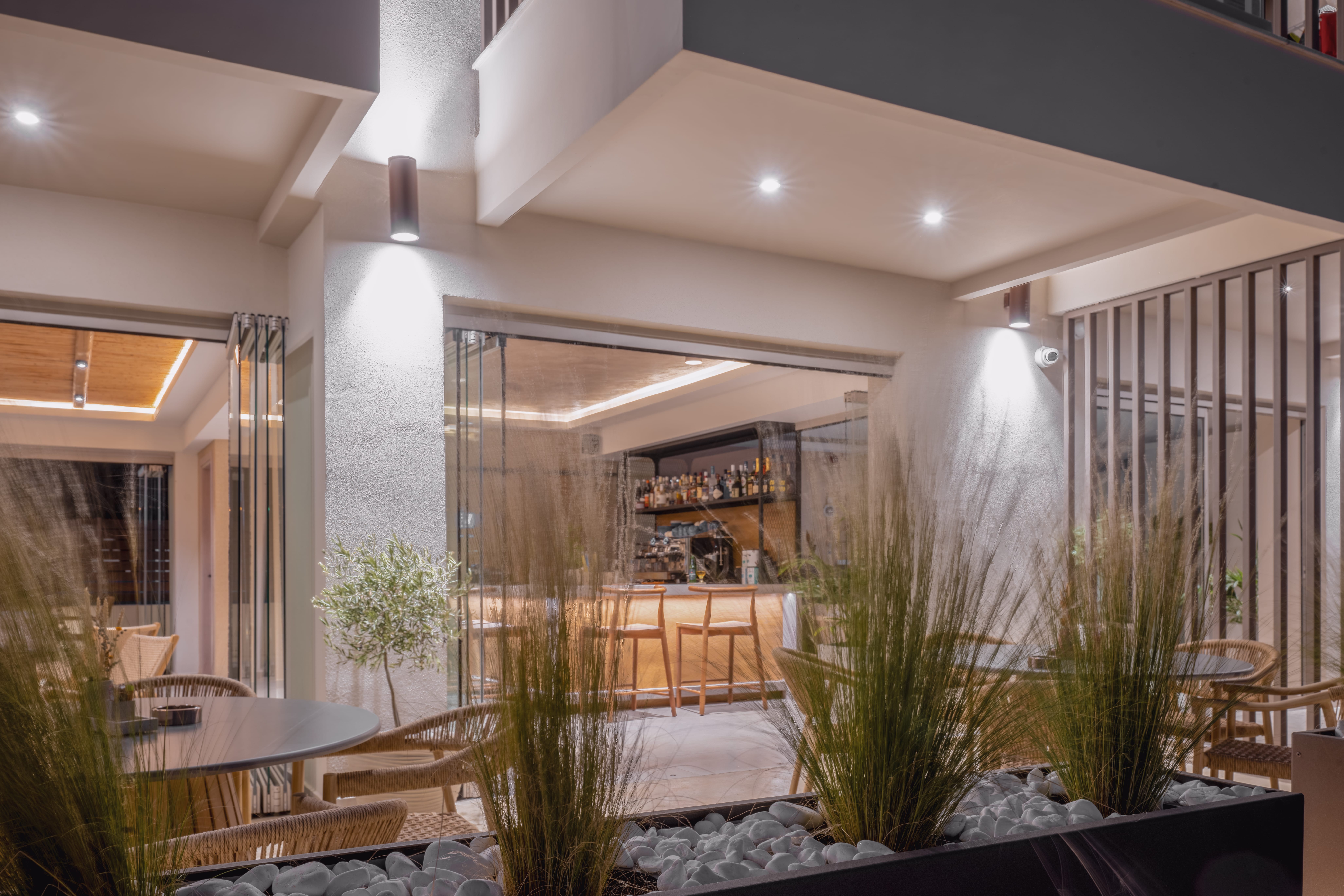 a room with a glass wall and plants