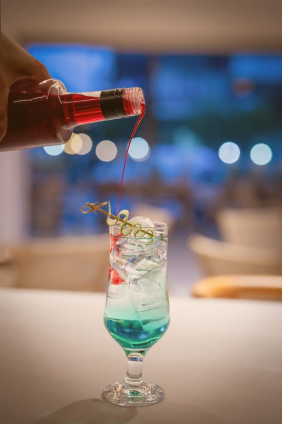 a glass with a liquid being poured into it