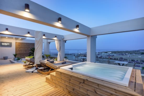 a pool with a deck and chairs