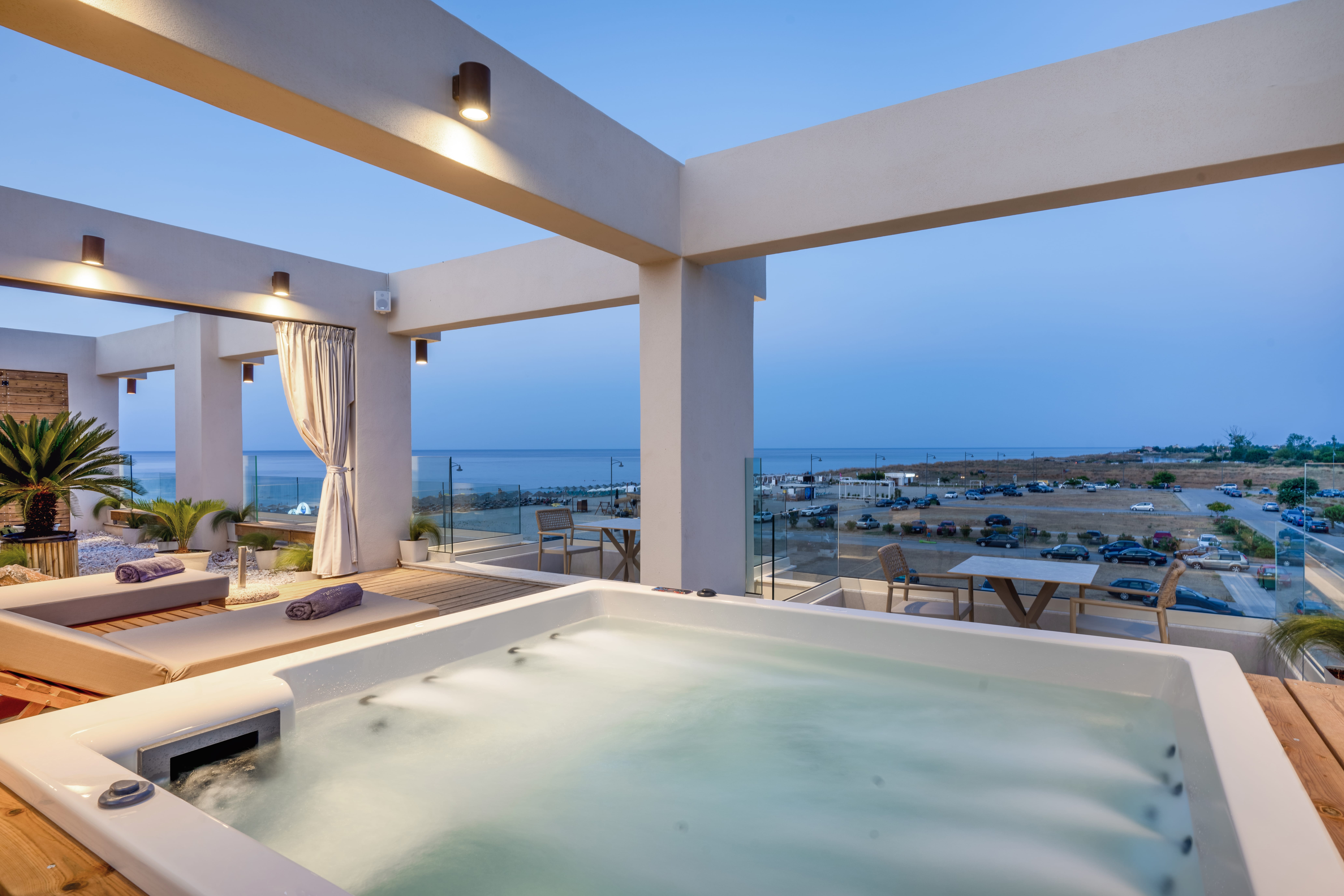 a pool with a view of the ocean and a beach