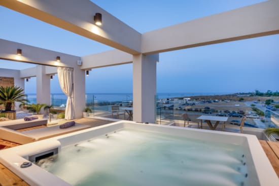 a pool with a view of the ocean and a beach
