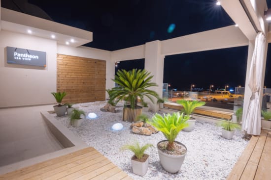 a room with plants and a stage