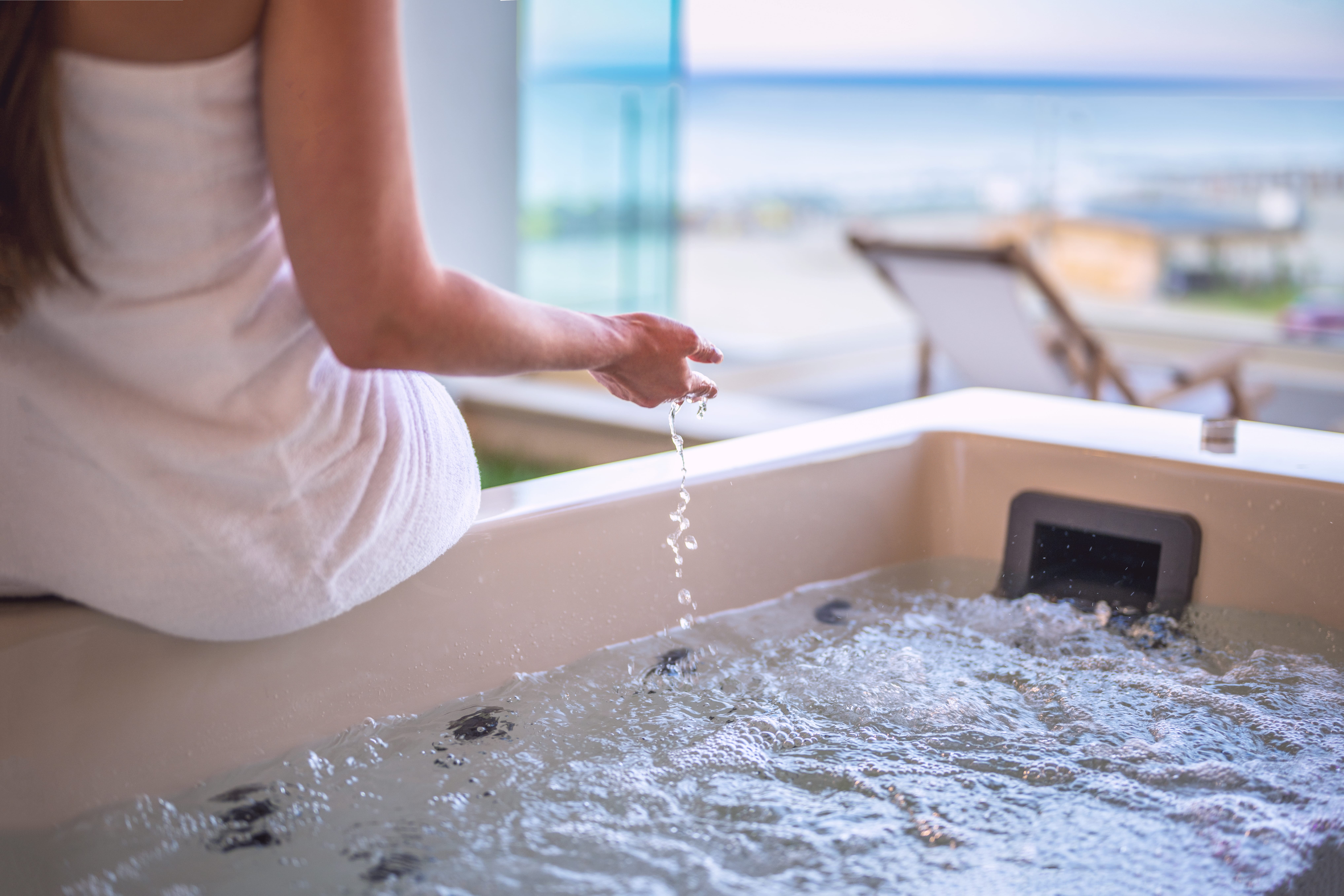 a woman pouring water into a sink