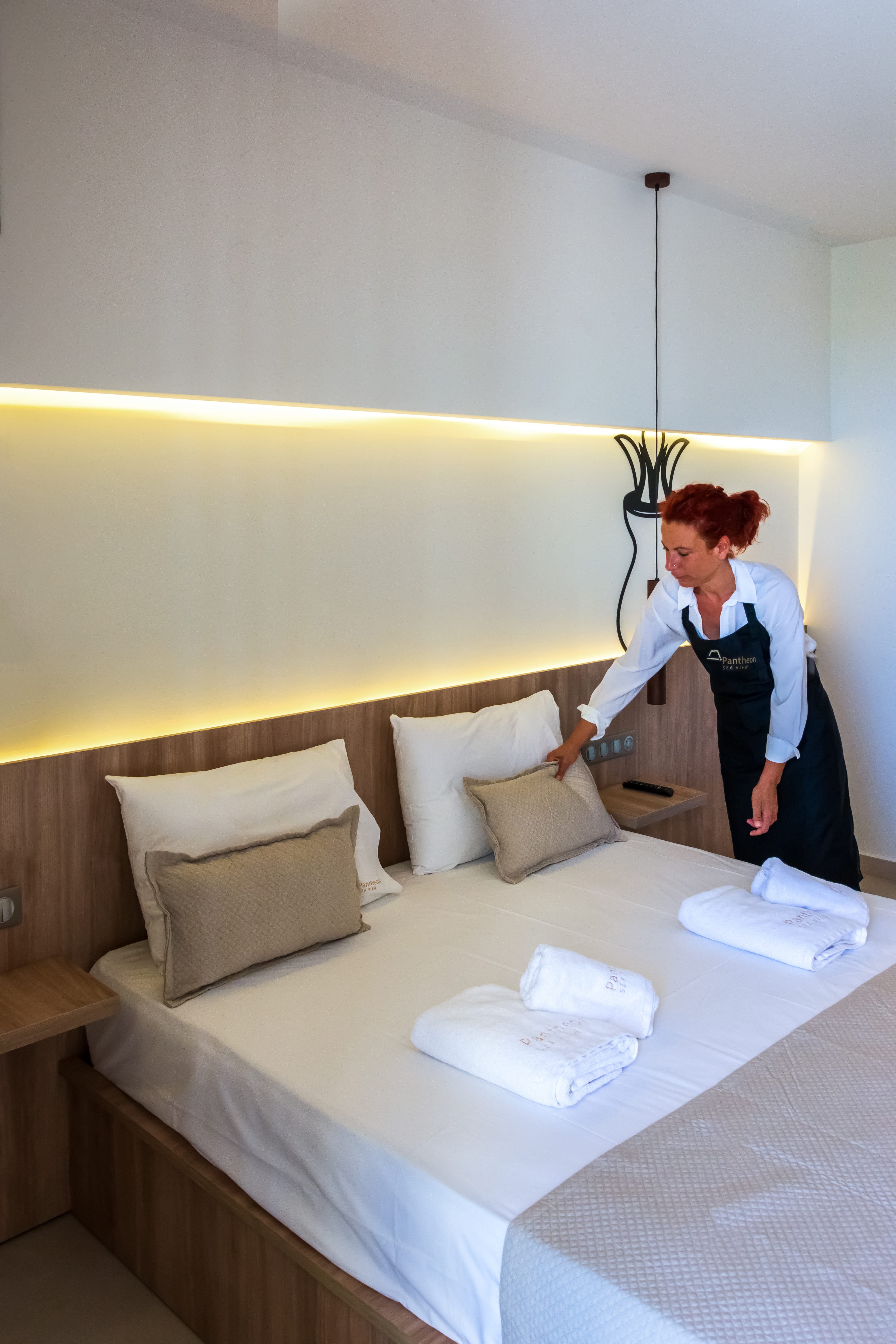 a person standing next to a bed