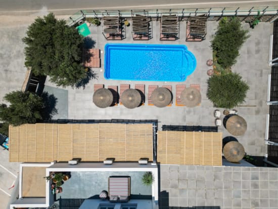 a room with a pool and a table with a pool and trees