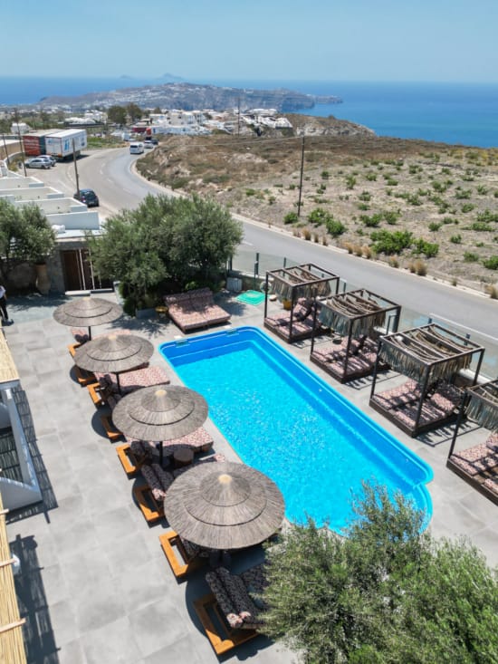 a pool with a beach and trees