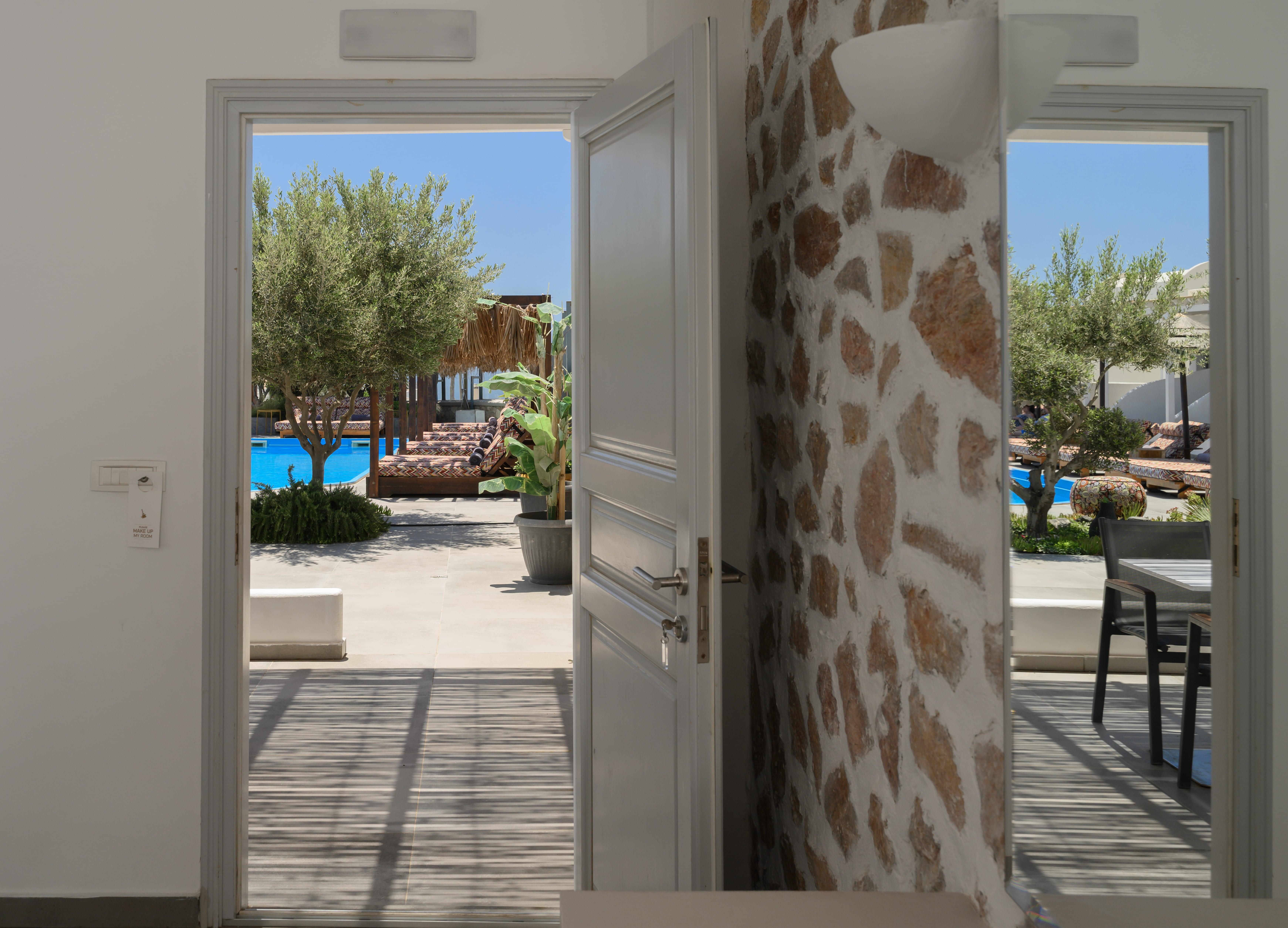 a door with a view of the street and trees