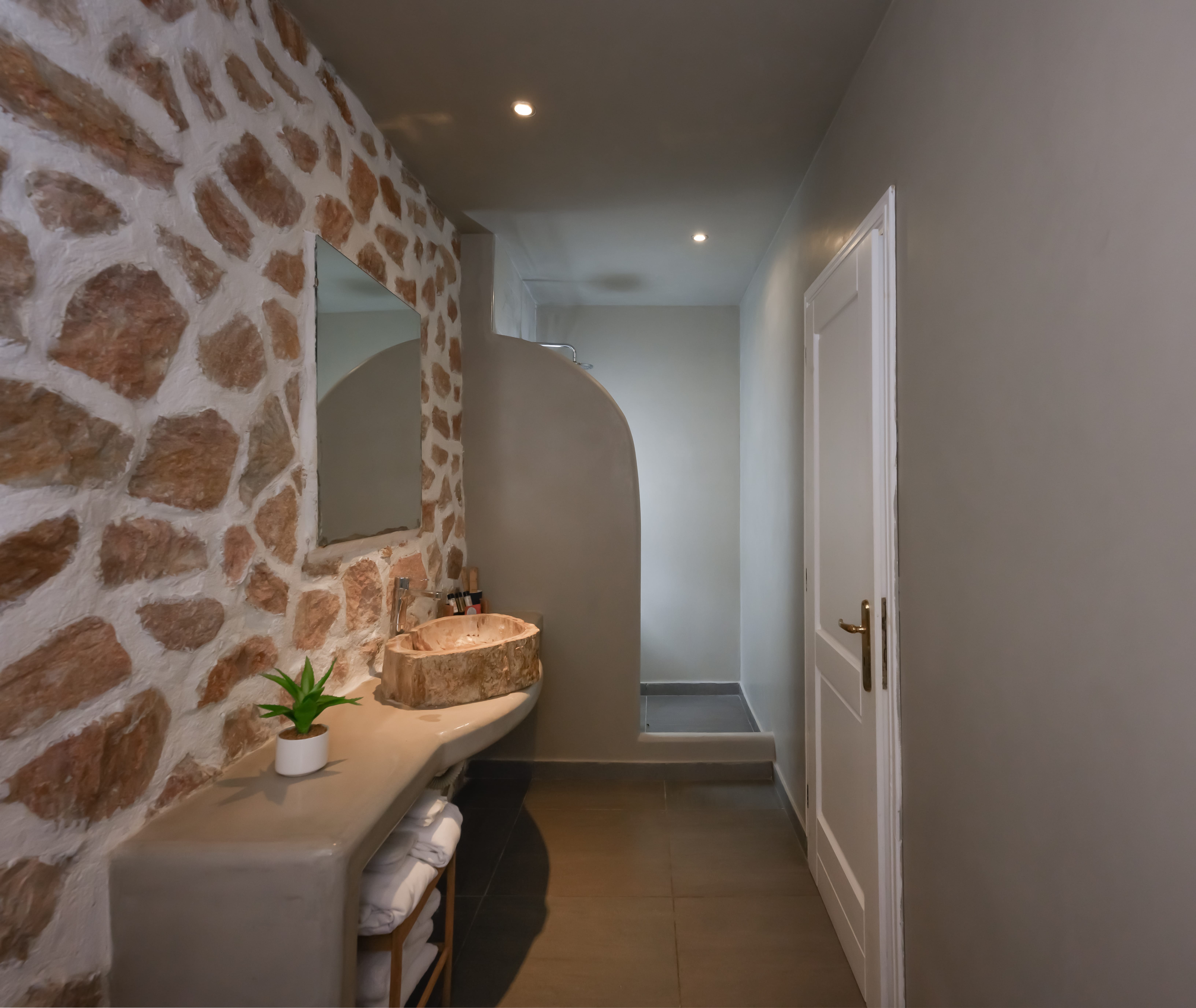 a room with a sink and a mirror