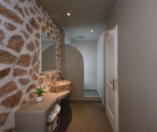 a room with a sink and a mirror