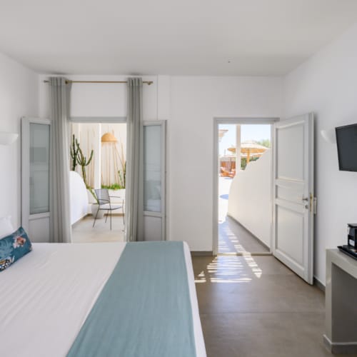 a room with a bed and a television