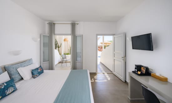 a room with a bed and a television