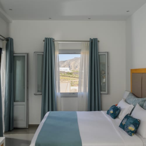 a bedroom with a bed and a tv