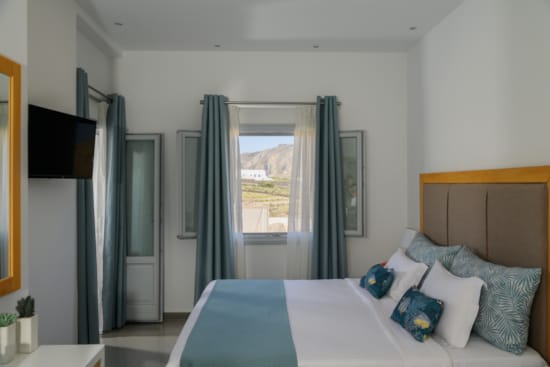 a bedroom with a bed and a tv