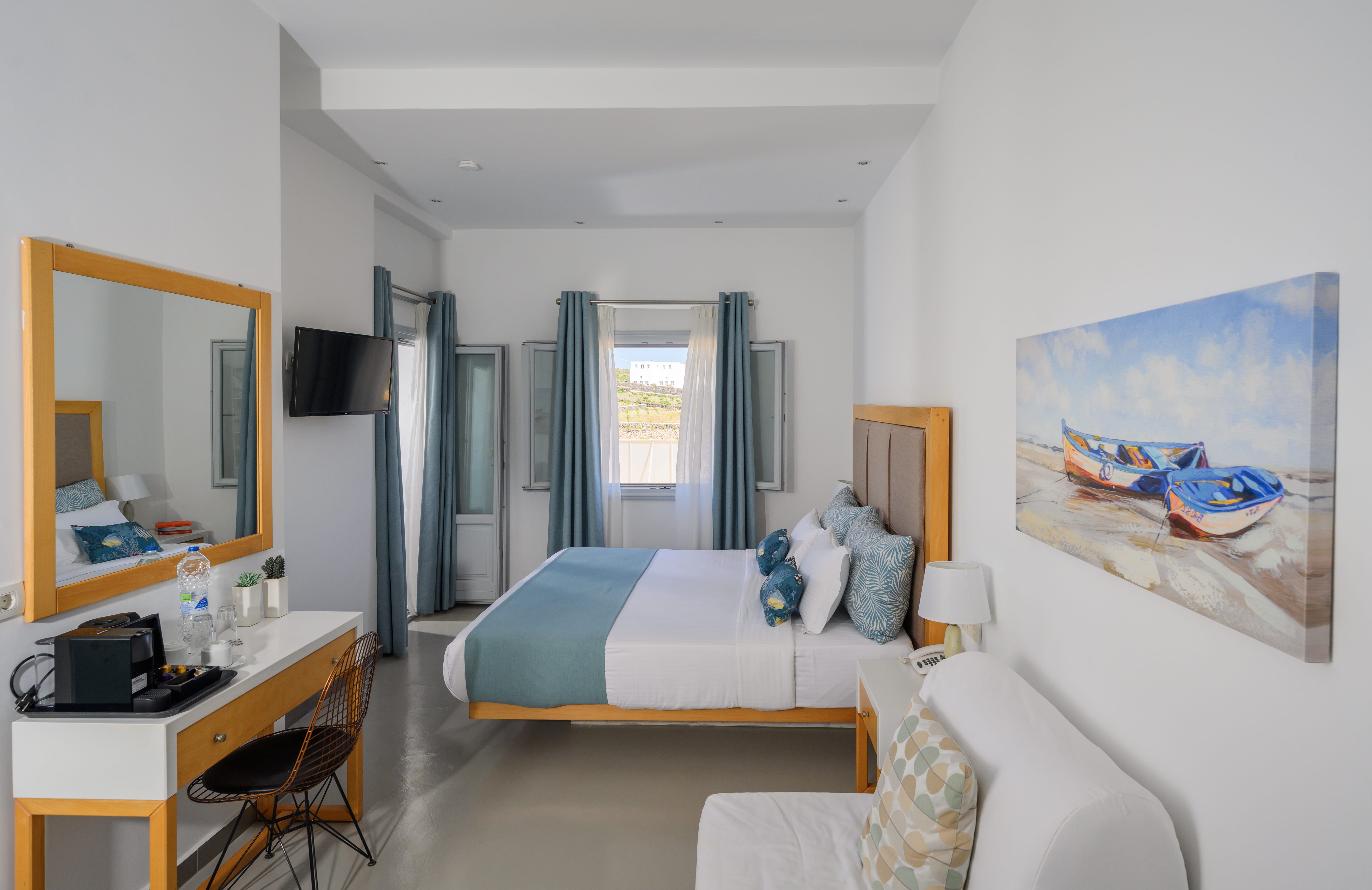 a room with a bed desk and a mirror