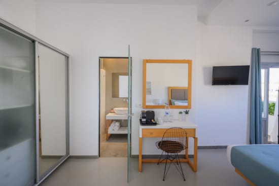 a room with a desk and a mirror