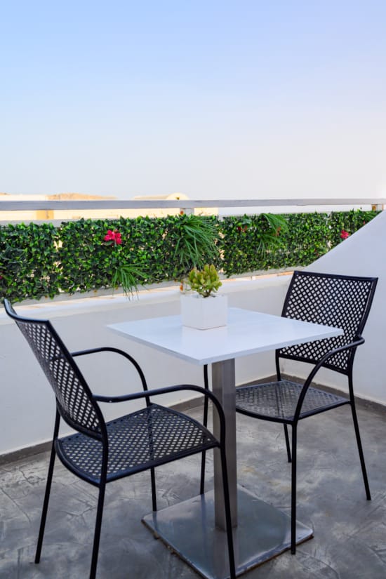 a table and chairs on a balcony