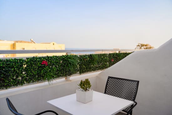 a table and chairs on a balcony