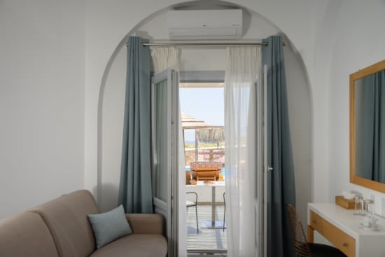 a room with a door and a window with a view of the city