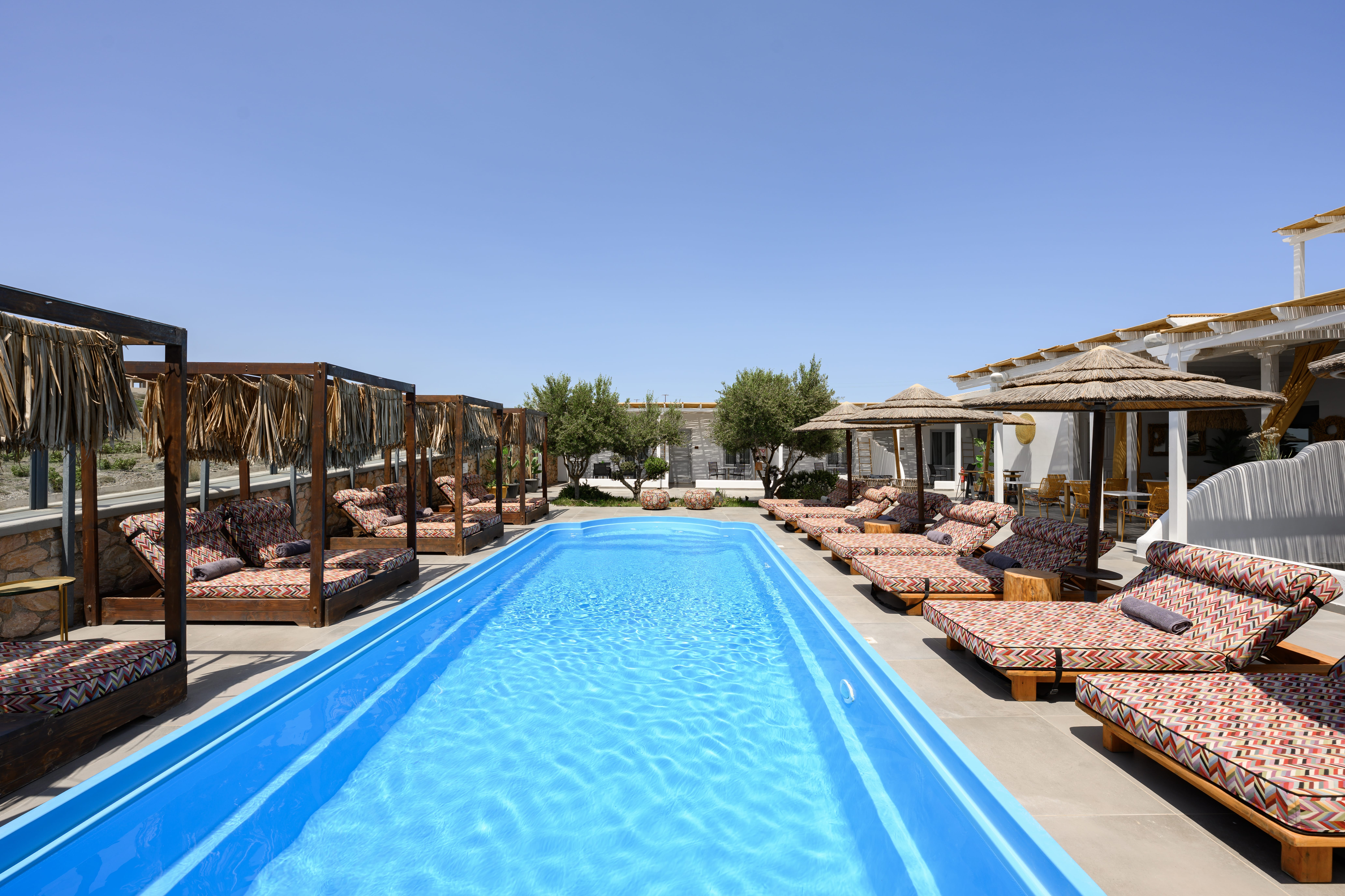 a swimming pool with lounge chairs around it