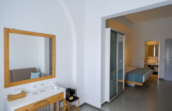 a room with a mirror and a couch