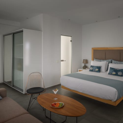 a bedroom with a bed and a coffee table