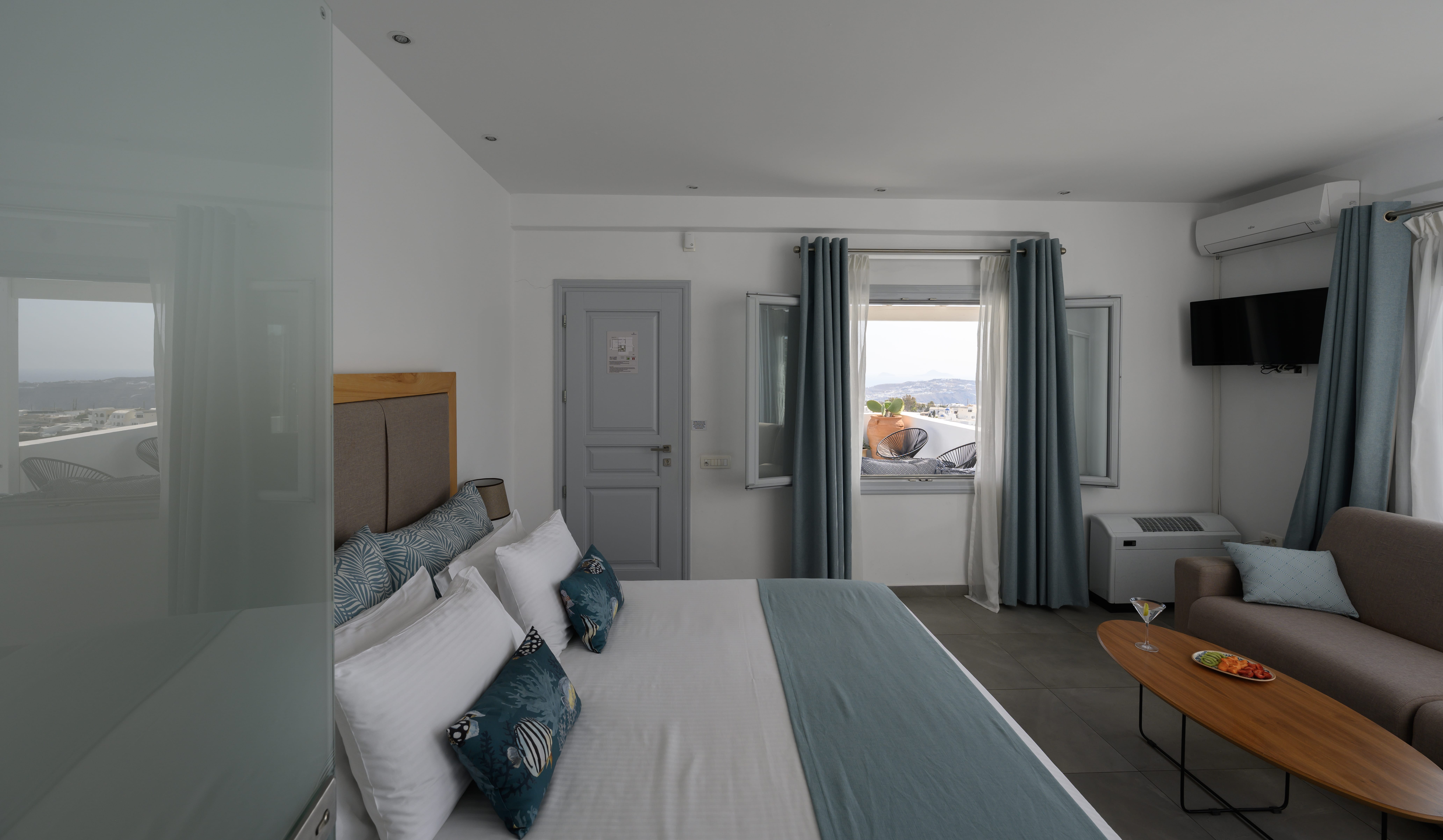 a room with a bed and couches