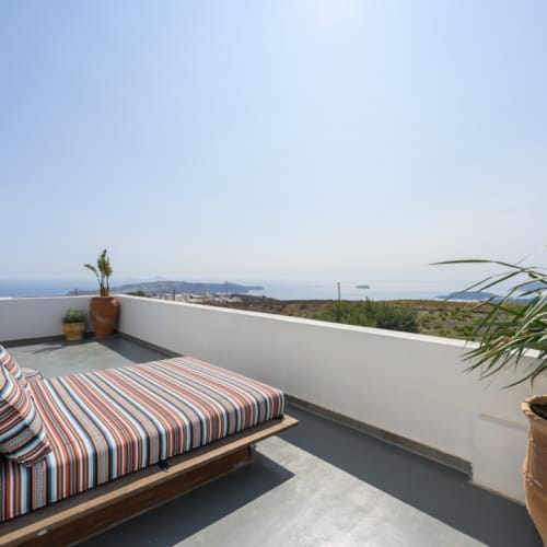 a deck with a table and potted plants on it