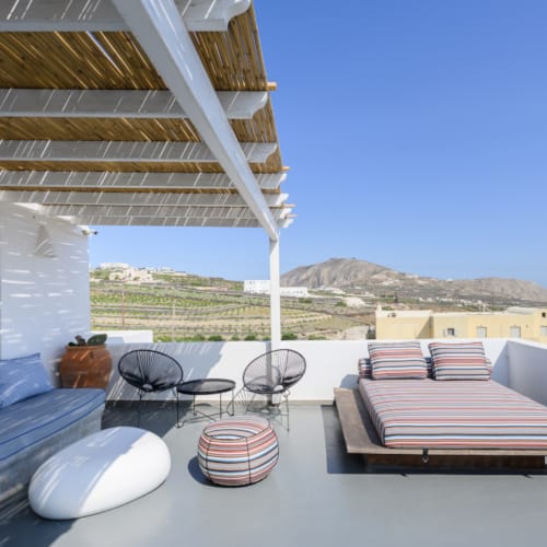 a deck with a pool and chairs