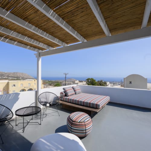 a deck with chairs and a table