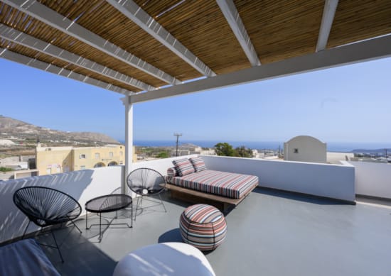 a deck with chairs and a table