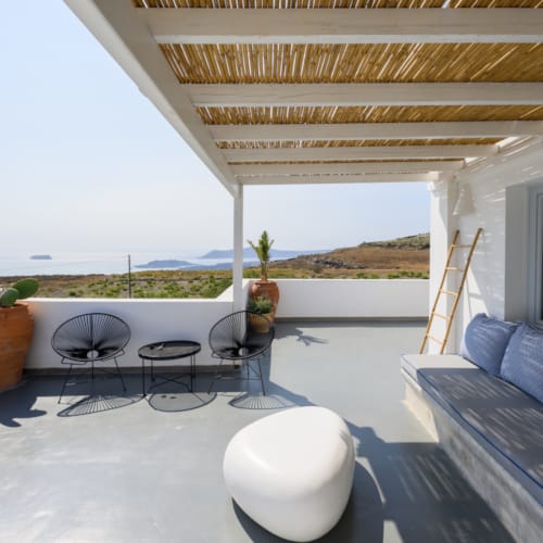 a patio with a table and chairs