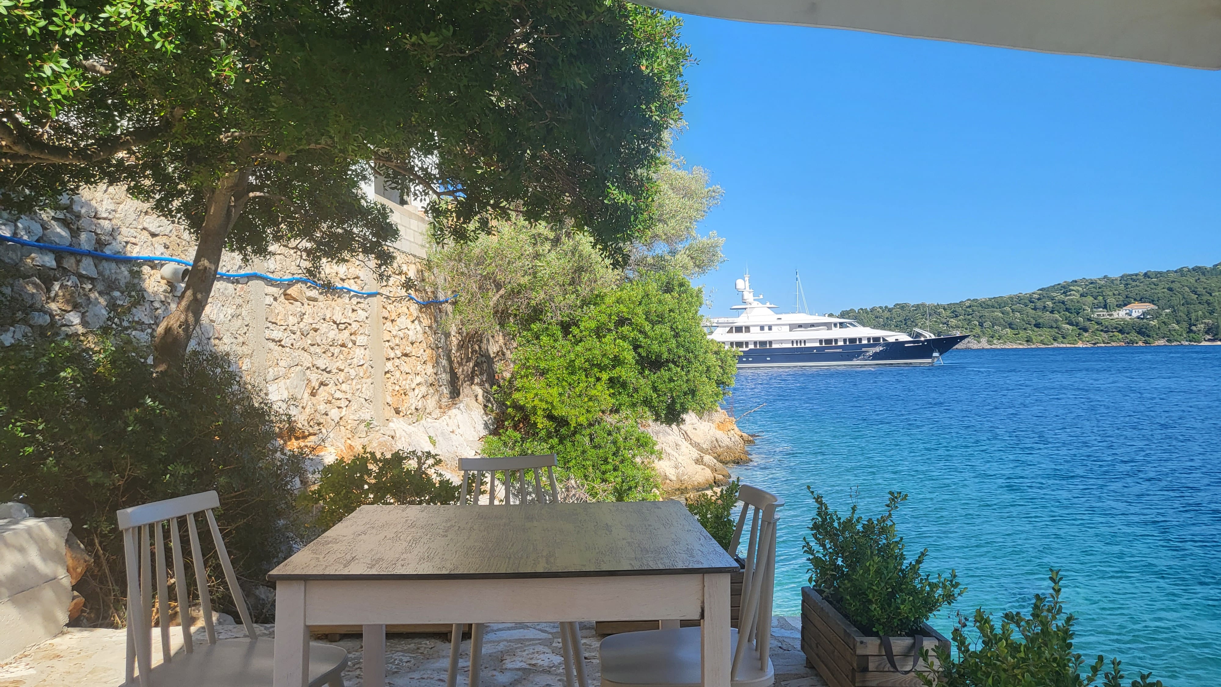 a table and chairs on a beach