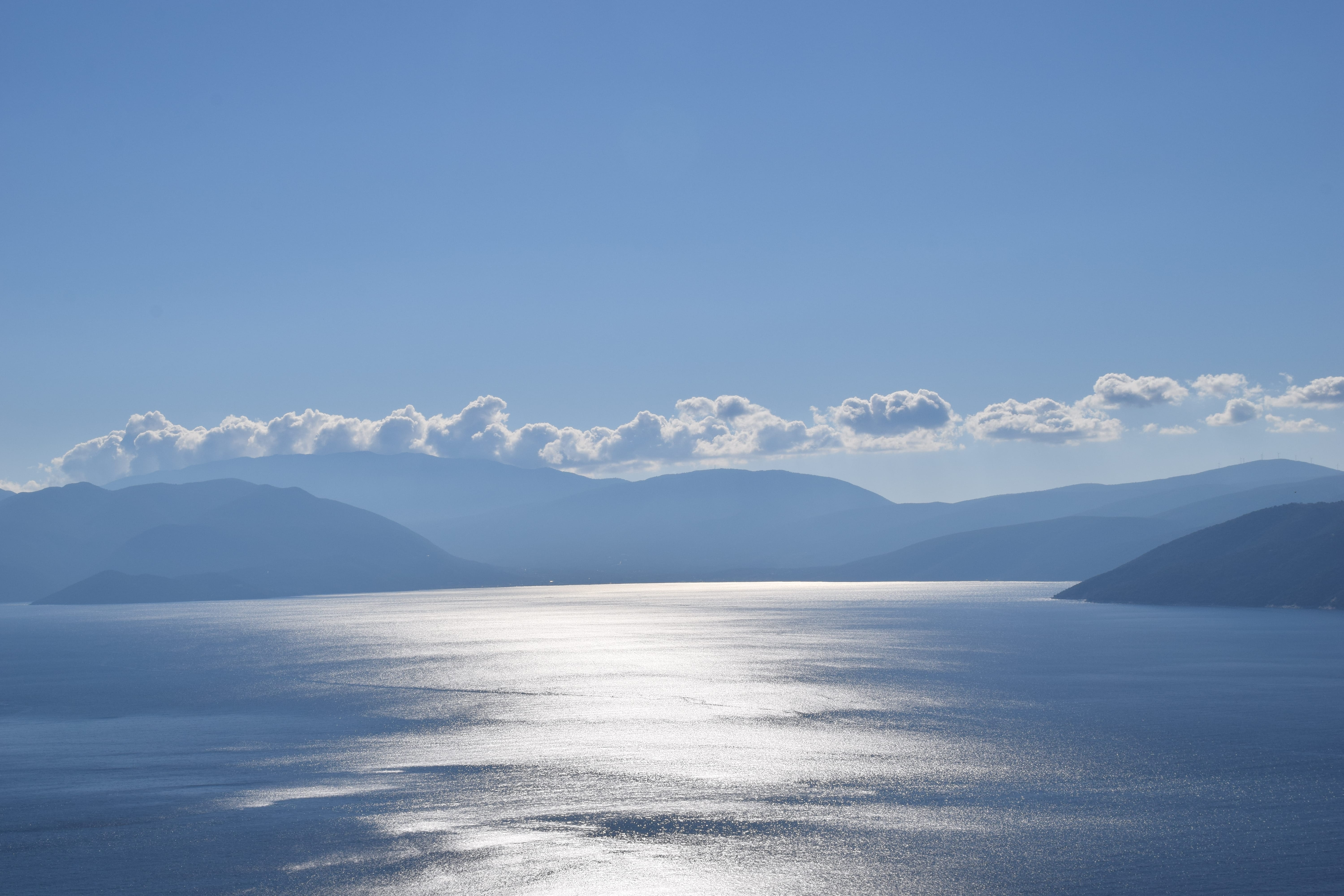 a body of water with mountains in the background