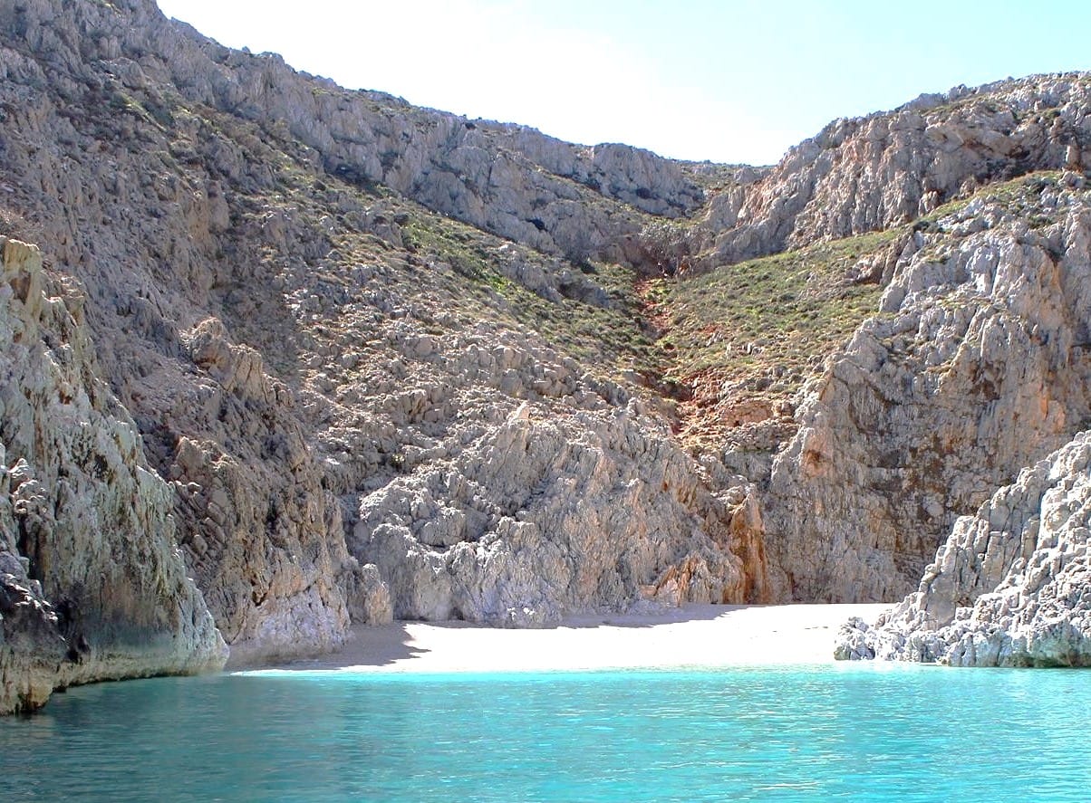 a body of water with rocky mountains around it