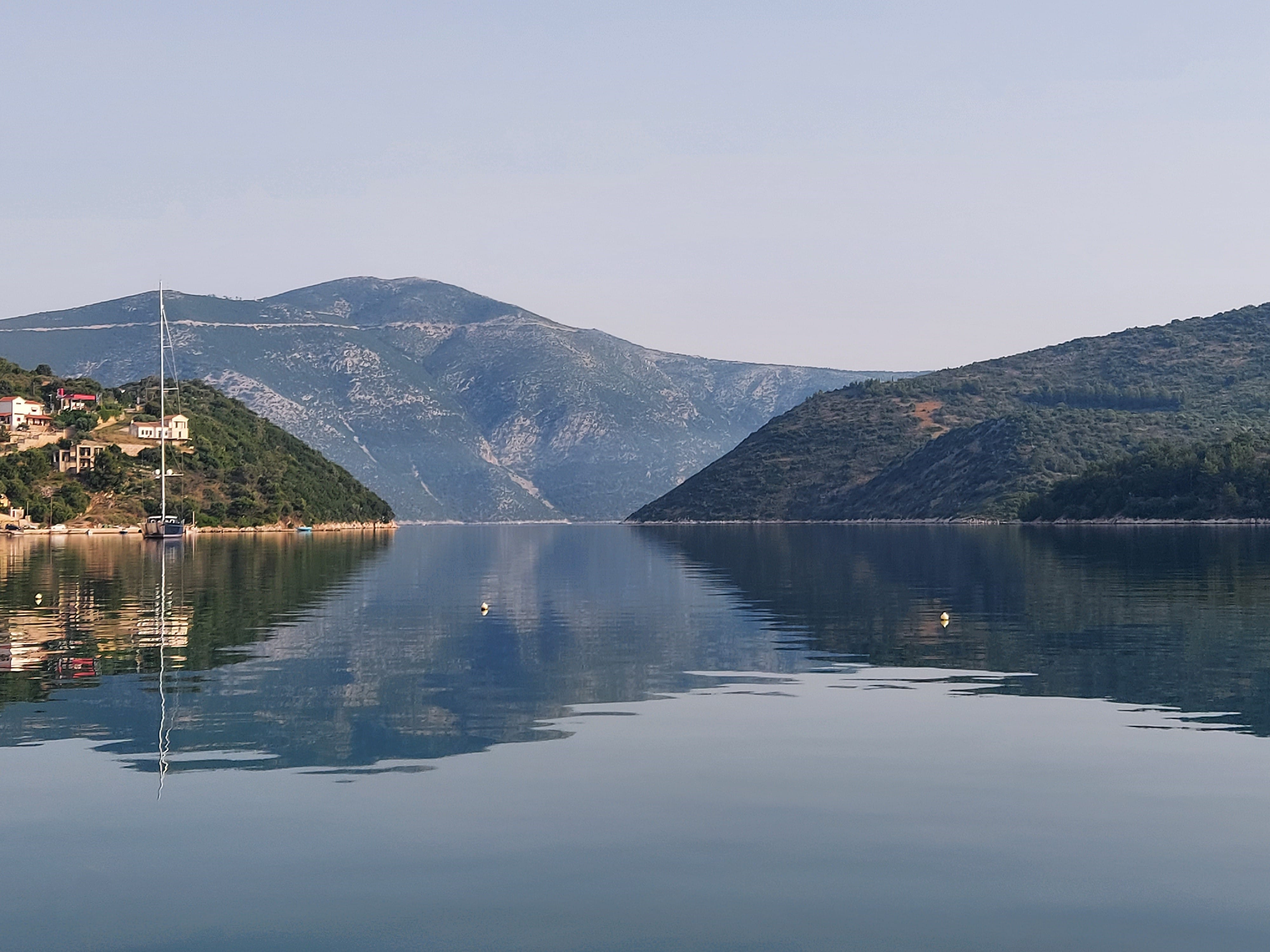a body of water with mountains in the background
