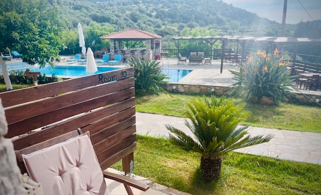 a deck with a pool and a lounge chair