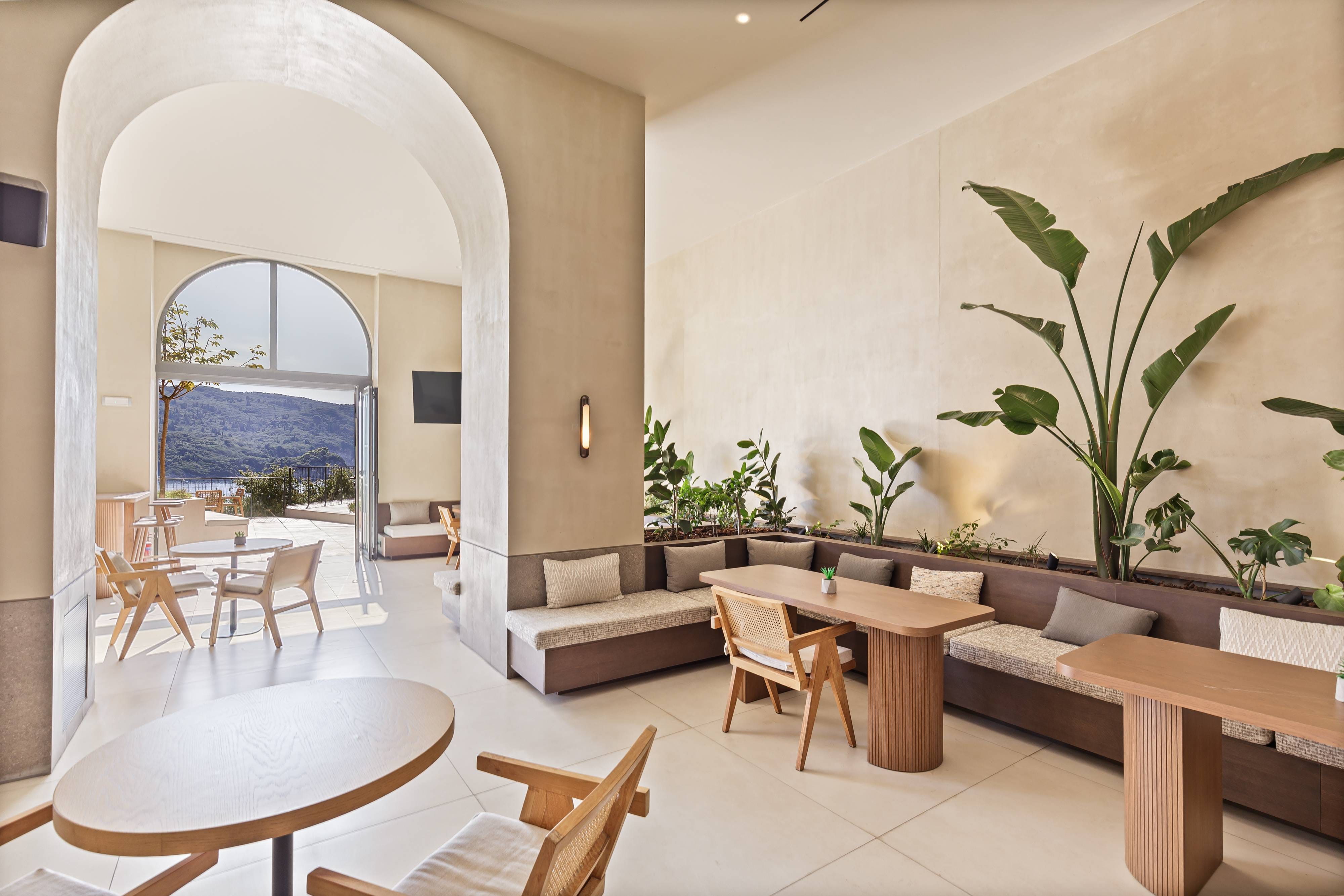 a room with a table chairs and a large window